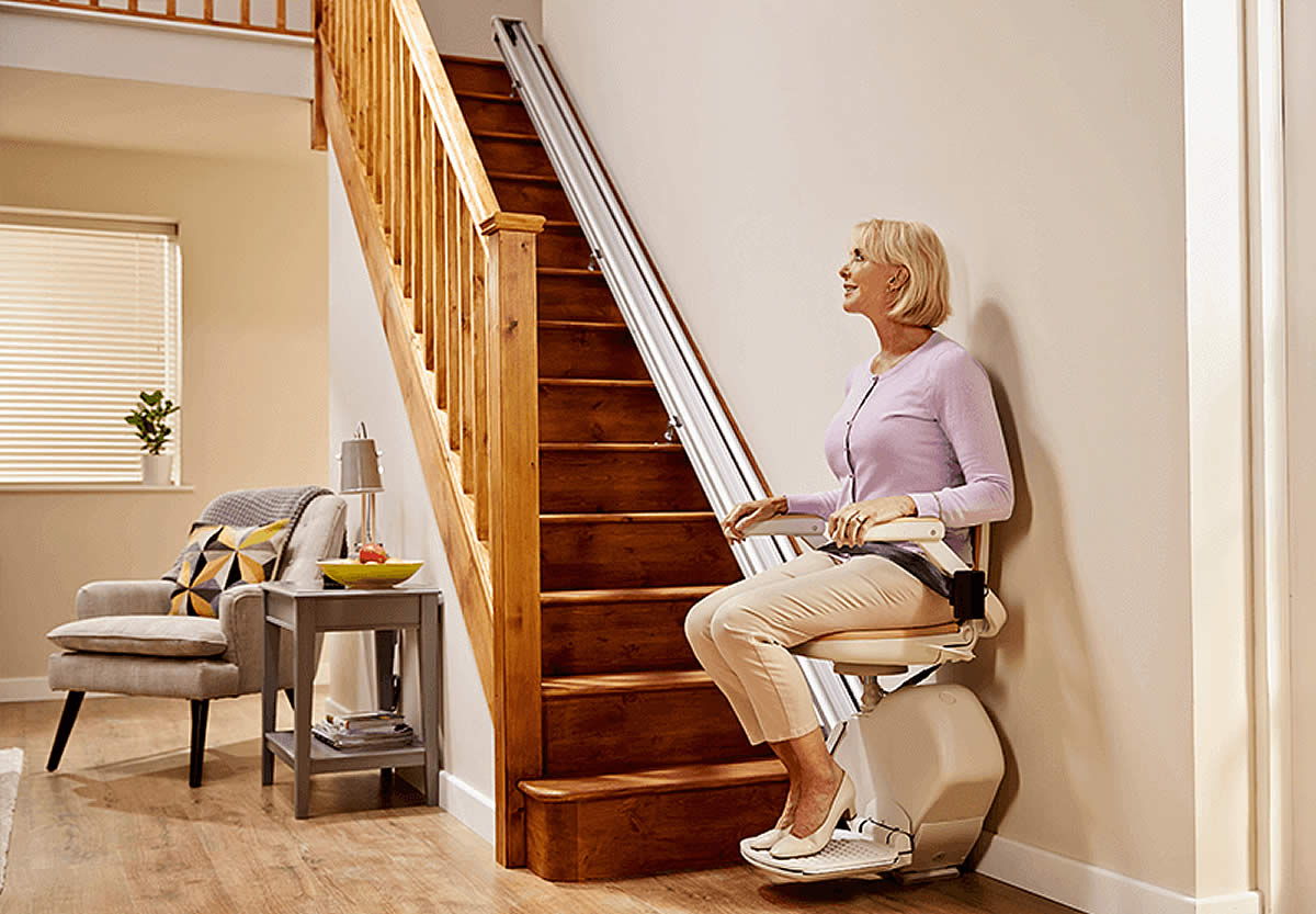 Old blonde lady using Stairlift