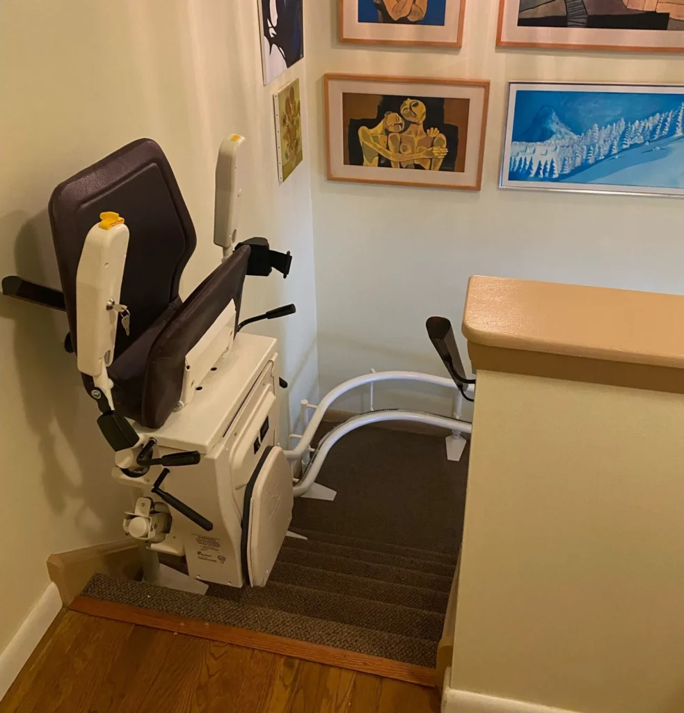 Installed curved stairlift parked beside the upper landing in a Brampton home