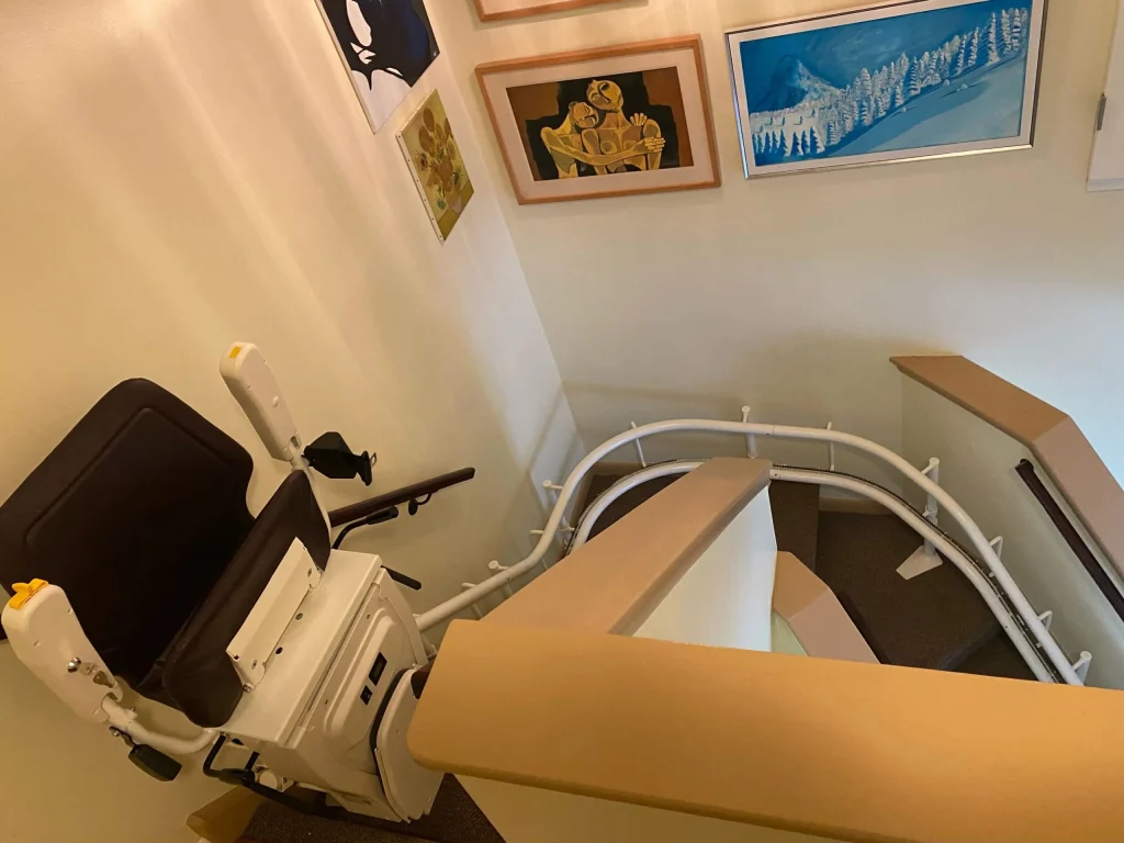 Custom curved stairlift rail installed along a staircase in a Brampton home